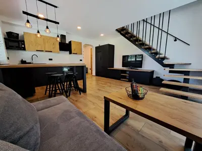 a living room with a couch and a table at Riverside Apartma 1, Kranjska Gora in Kranjska Gora