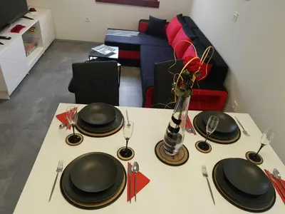 a table with black plates and silverware on it at Apartma Devs in Kranjska Gora