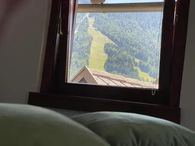 a window with a view of a mountain view at Apartma Devs in Kranjska Gora