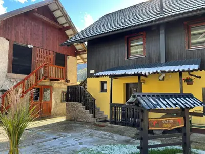 a house with a yellow and brown building at Apartma Devs in Kranjska Gora