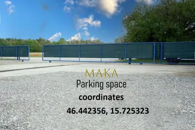 a sign for a parking space with a bench at Apartma Maka in Maribor