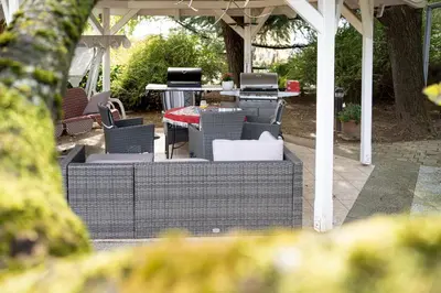 acovered patio with chairs and a table and a tablektop at Apartma Maka in Maribor