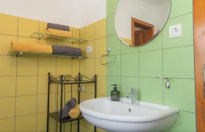 a bathroom with a sink and a mirror at Nad tunelom apartment Bohinj in Bohinj