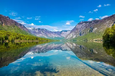 a view of a lake with mountains in the background at Nad tunelom apartment Bohinj in Bohinj