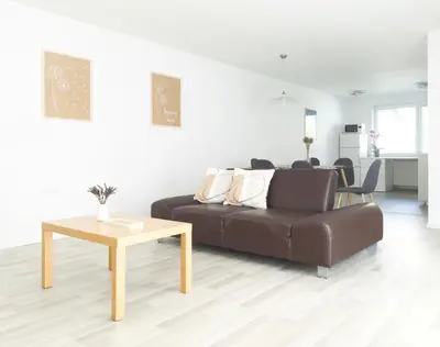 a living room with a couch and a table at Harmony House Velenje in Velenje