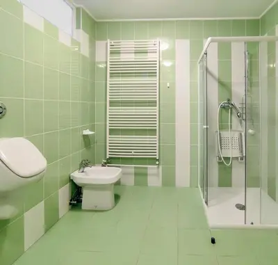a green and white bathroom with a sink and a shower at Harmony House Velenje in Velenje