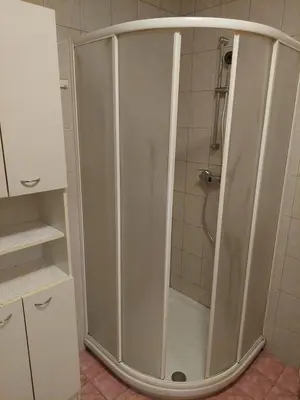 a shower with a glass door in a bathroom at Apartma Kaj in Kaja in Maribor