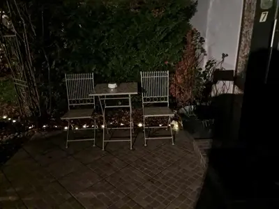 a table and two chairs on a patio at night at ART ROOM in Rose resort in Ljubljana