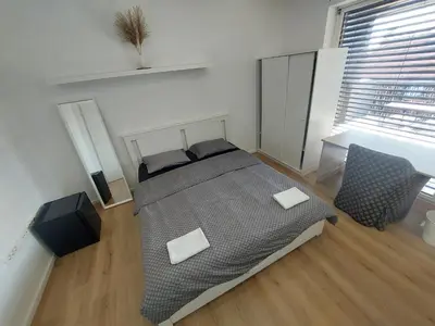 a bedroom with a bed with two pillows on it at ROSE VALLEY, modern studios & apartments in Ljubljana
