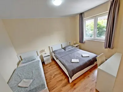 a bedroom with two beds and a window at ROSE VALLEY, modern studios & apartments in Ljubljana