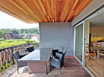 a patio with a table and chairs on a balcony at ROSE VALLEY, modern studios & apartments in Ljubljana