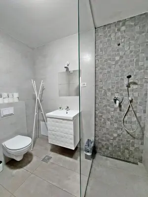 a bathroom with a shower and a toilet and a sink at ROSE VALLEY, modern studios & apartments in Ljubljana