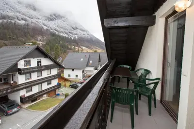a balcony with two chairs and a view of a mountain at Apartment Planika in Bohinj