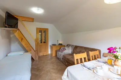 a living room with a couch and a table at Apartments Omahen in Bohinj