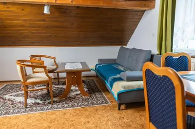 a living room with a couch and a table at Apartments Darinka Mencinger in Bohinj