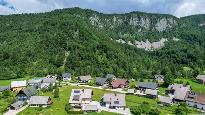 an aerial view of a village in front of a mountain at Apartments Darinka Mencinger in Bohinj