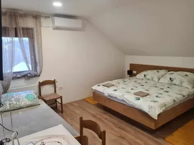 a small bedroom with a bed and a table at Turistično - Izletniška kmetija Žerjav in Brežice