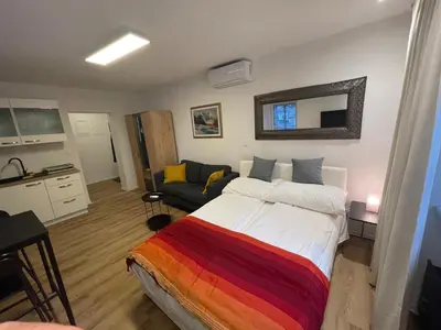 a bedroom with a large bed and a couch at Celje Luxury Apartment in Celje