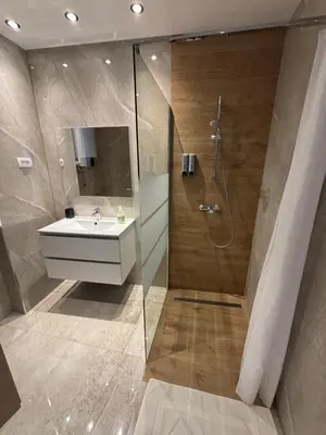 a bathroom with a sink and a shower at Celje Luxury Apartment in Celje