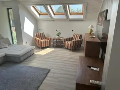 a living room with a couch and chairs and a table at A&E Apartment in Ljubljana