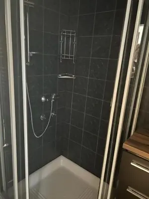 a bathroom with a shower with a bath tub at A&E Apartment in Ljubljana