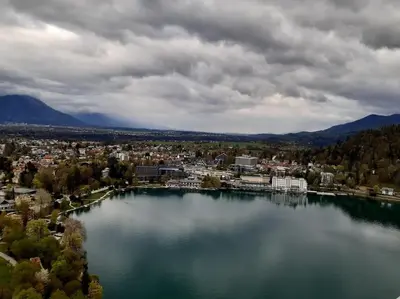a view of a large body of water with a city at Apartma Kenda in Bled