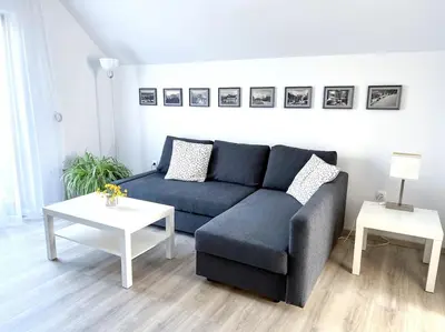 a living room with a blue couch and a table at Apartma Kenda in Bled