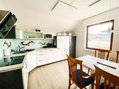 a kitchen with a table and a dining room at Apartma Kenda in Bled