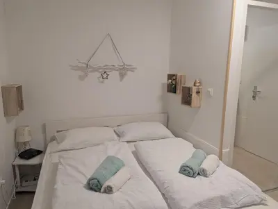 a white bed with two towels on top of it at Apartment Lilija in Bovec