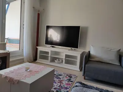 a living room with a flat screen tv on a white cabinet at Apartment Lilija in Bovec