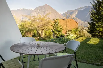 a table and chairs with a view of mountains at Apartment Lilija in Bovec