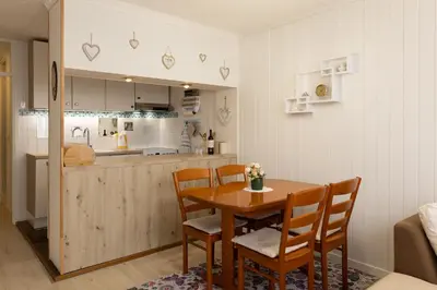 a kitchen and dining room with a table and chairs at Apartment Lilija in Bovec
