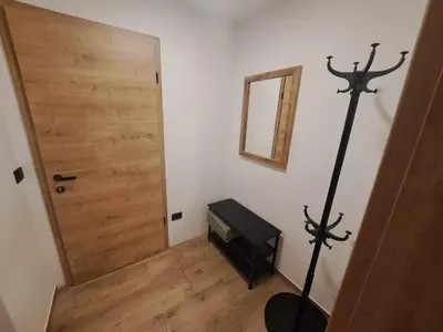a room with a wooden door and a mirror at Riverside Apartma 2, Kranjska Gora in Kranjska Gora