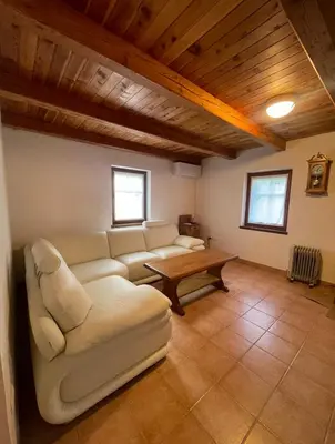a living room with a couch and a table at Juliana Cottage in Soča