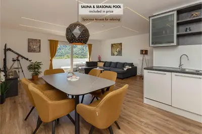 a kitchen and living room with a table and chairs at Holiday House Žalec in Griže