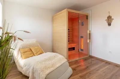 a room with a glass shower with a couch at Holiday House Žalec in Griže