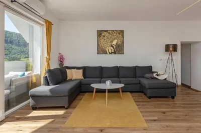a living room with a couch and a table at Holiday House Žalec in Griže