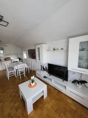 a living room with a large television and a table at Apartmaji Peric in Ljubljana
