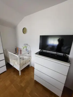 a white dresser with a flat screen tv on top at Apartmaji Peric in Ljubljana