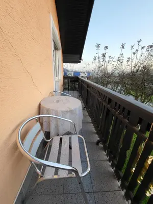 a metal bench with a table on a balcony at Apartmaji Peric in Ljubljana