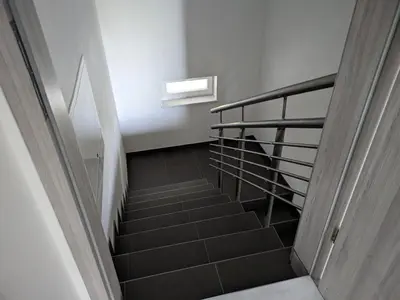 a staircase in a building with a stair case at Počitniška hiša Hum in Kojsko