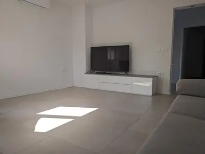 a living room with a flat screen tv and a couch at Počitniška hiša Hum in Kojsko