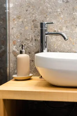 a bathroom sink with a soap dispenser on a wooden counter at Panorama 13 in Tolmin