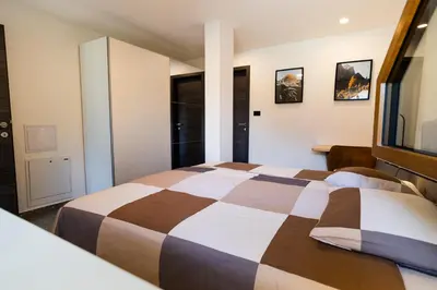 a hotel room with a bed and a window at Panorama 13 in Tolmin