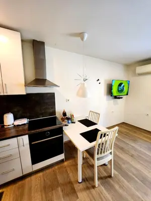 a kitchen with a table and a stove top oven at Studio Apartma V8 in Maribor