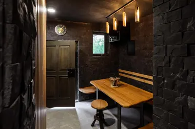 a dining room with a wooden table and a brick wall at Villa in the Vineyard with Pool, HotTub & Sauna in Lendava