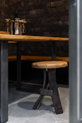 a wooden table with a wooden stool on a table at Villa in the Vineyard with Pool, HotTub & Sauna in Lendava