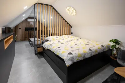 a bedroom with a bed with a wooden headboard at Villa in the Vineyard with Pool, HotTub & Sauna in Lendava