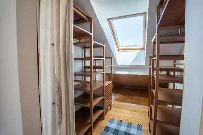 a room with wooden shelves and a window at Horse Farm Holiday Pr' Kolenc in Zgornje Gorje