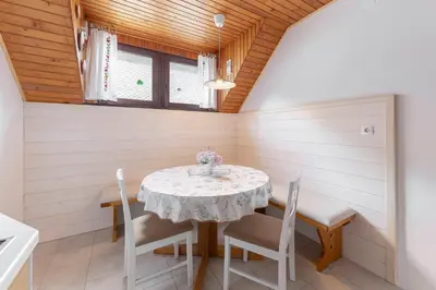 a dining room with a table and chairs at Apartma Mikelj in Bohinj